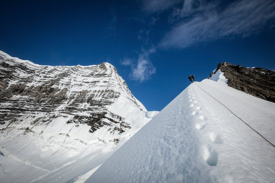 Climber climbing Mount Robson in winter