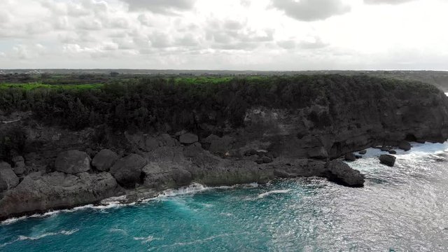 Stunning drone shot overlooking limestone hills and beautiful blue ocean waters