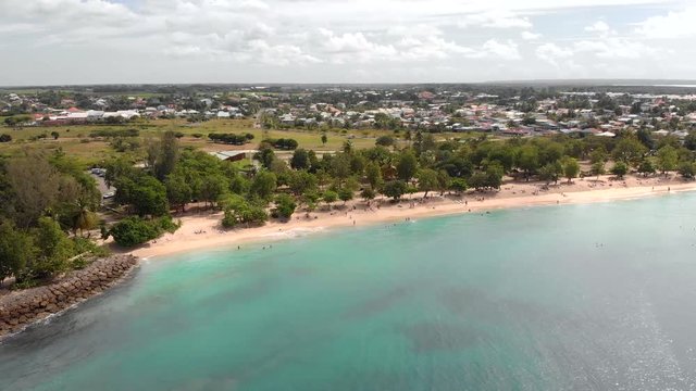 Somber aerial shot over beautiful blue water and a sandy beach in Guadeloupe