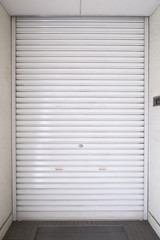 A white shutter of the building entrance