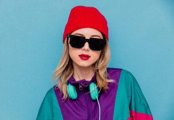 woman in red hat, sunglasses and suit of 90s with headphones