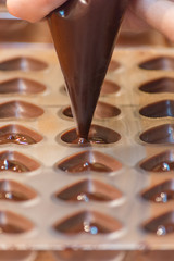 Part of the process of making homemade artisan chocolate sweets with different fillings for a special ocassion: valentine's day, a birthday or anniversary gift or the perfect souvenir