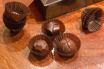 Close-up of three filled chocolates. Making homemade artisan chocolate sweets with different fillings for a special ocassion: valentine's day, a birthday or anniversary gift or the perfect souvenir