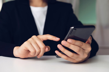 woman holding smartphone,  using cell phone on cafe. Technology for communication concept.