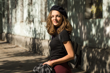 Naklejka premium The girl in beret and skirt in the park 