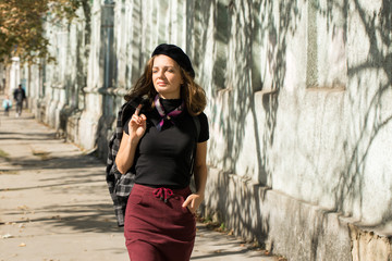 The girl in beret and skirt in the park	