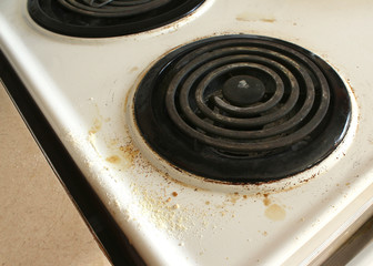 dirty and beat up coil stove top