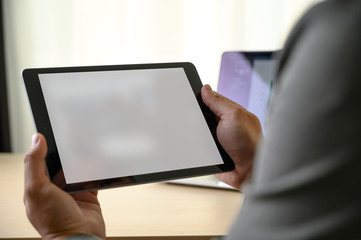 Fototapeta na wymiar man hands multitasking man using tablet close up close up working in office