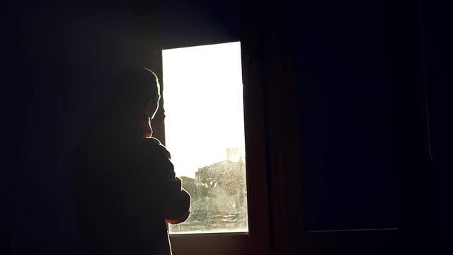 Close up shot of silhouette man open striped blinds on a window in dark dirty window jalousie installing apartment interior inside light view close up flat slow motion