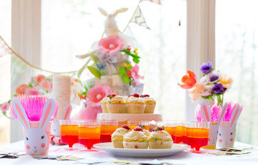 Dessert table with cupcakes and flowers Easter party theme