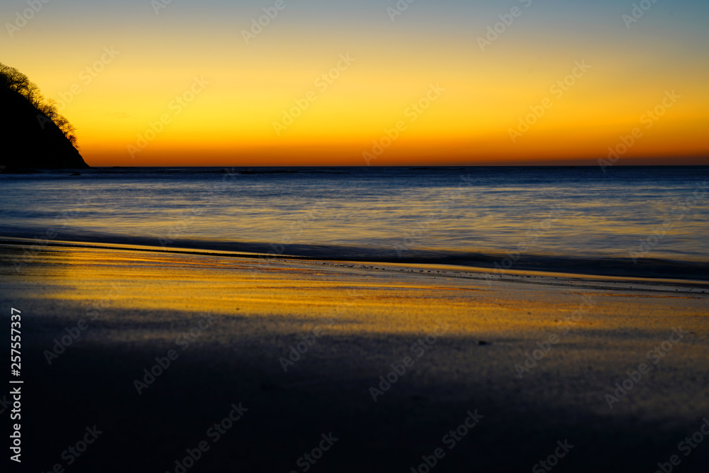 Wall mural dramatic orange sunset sky over the playa virador beach in peninsula papagayo, guanacaste, costa ric