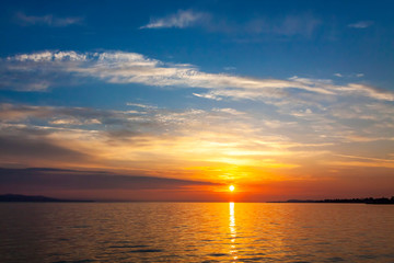 Naklejka na ściany i meble Sunrise over the Balaton lake, Hungary. Pastel morning colors of the lake and sky