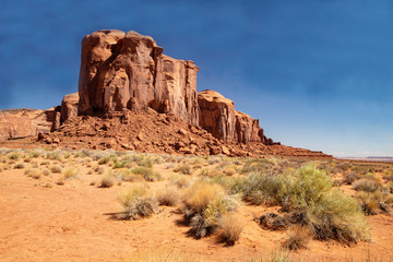 Fototapeta premium Monument Valley famous rock formations under a blue sky.