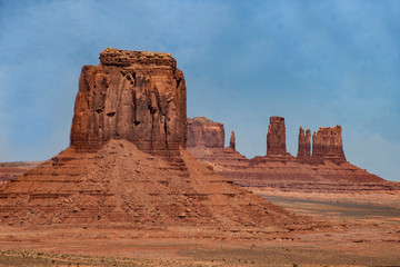 Fototapeta premium Monument Valley famous rock formations under a blue sky.