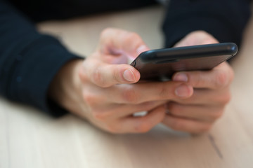 Woman hands typing on smart phone sending messages