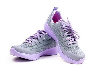 Pair of unbranded purple color sport or running shoes on a white background