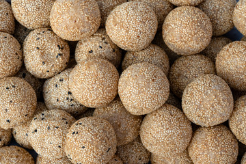 Coconut rice balls with sesame seeds is traditional Thai dessert made from rice flour and coconut milk at street food market in Thailand