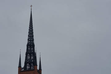 Fototapeta na wymiar Clocktower of Stockholm Cathedral - Riddarholmskyrkan church against a cloudy sky. Copy space. 