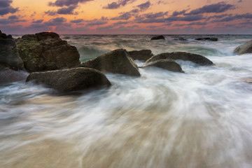 Beautiful Tropical seascape wave hit the rock during sunset