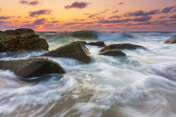Beautiful Tropical seascape wave hit the rock during sunset