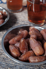 Bowl of dates fruit and glass of tea, usually consumed when break fasting