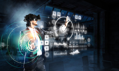 Fototapeta premium Businessman having VR experience. Mixed media