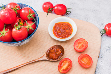 A plate of ketchup and tomatoes
