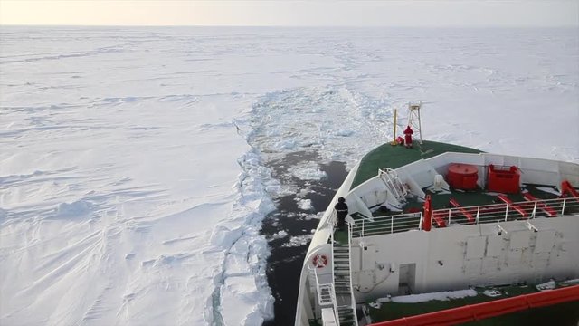 Research icebreaker cruising through breaking packed ice in Weddell Sea of Antarctica during winter