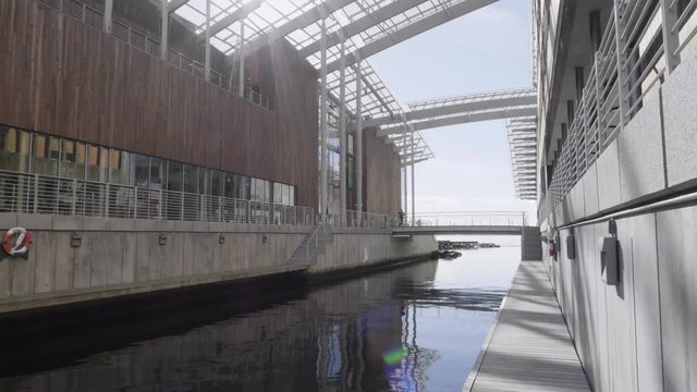 4K video with forward motion of the popular tourist destination Tjuvholmen, located on the tip of Aker brygge, with a wooden building, a bridge and a canal to the Oslo fjord, with lens flare.