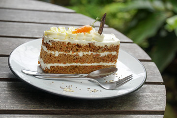 Delicious sliced carrot cake on wood table.