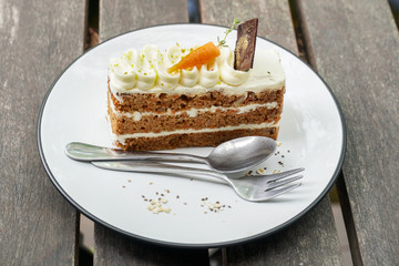 Delicious sliced carrot cake on wood table.