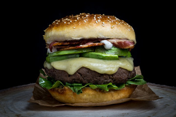 Cheeseburger with bacon, avocado, lettuce and mayonnaise