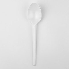 clear white plastic spoon on white background, ecological problem, closeup, square photo