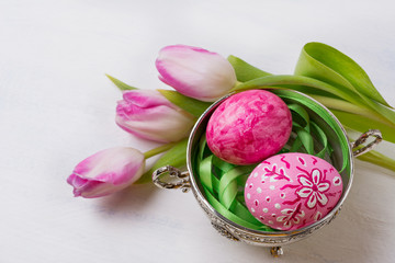 Easter background with pink eggs in the metal bowl