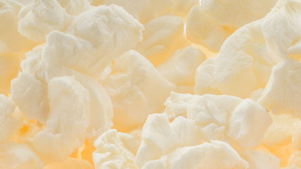 Popped buttered popcorn macro background - amazing detail and texture of fluffy popped kernels