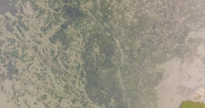 Aerial: The dykes and shoreline of the Oosterschelde, the Netherlands. Filmed during a hazy sunset.