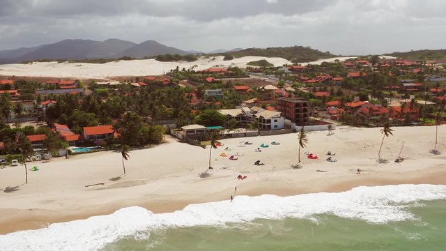 Aerial: Cumbuco during day with people kitesurfing.