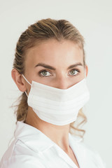 Female nurse, doctor or scientist wearing mouth mask - COVID-19 coronavirus pandemic themed