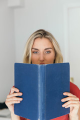 Blonde caucasian woman reading a book