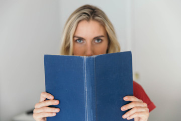 Blonde caucasian woman reading a book