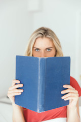 Blonde caucasian woman reading a book