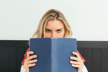 Blonde caucasian woman reading a book