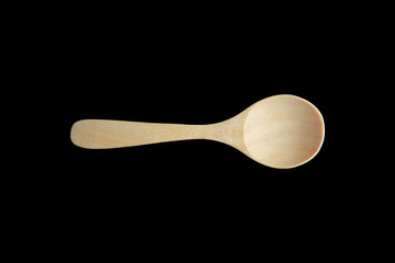 A Wooden spoon isolated on black background. Top view.