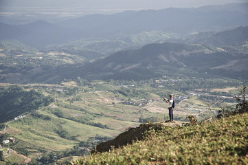 traveler on mountain cliff