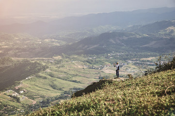Fototapeta na wymiar traveler on mountain cliff