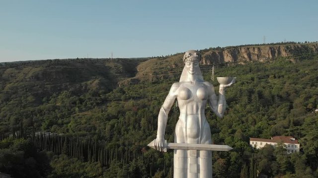 Quadcopter fly to the Kartlis Deda, Mother of Georgia statue in capital of Georgia, Tbilisi. From bottom to top view. Slow motion. Aerial video