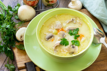 Cream soup with cream, chicken and mushrooms on a rustic-style kitchen table. American cuisine.