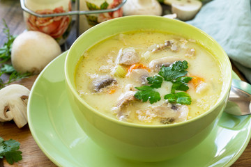 Cream soup with cream, chicken and mushrooms on a rustic-style kitchen table. American cuisine.