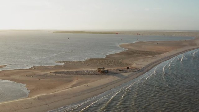 Aerial: The lagoon of Atins, Brazil during sunset with people kitesurfing.