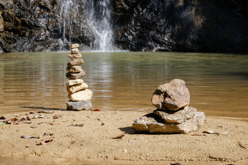 The stones are stacked at the waterfall.